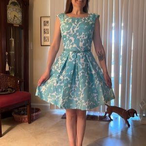 Polyester sateen, sleeveless summer dress goes from washer to hanger with ease.